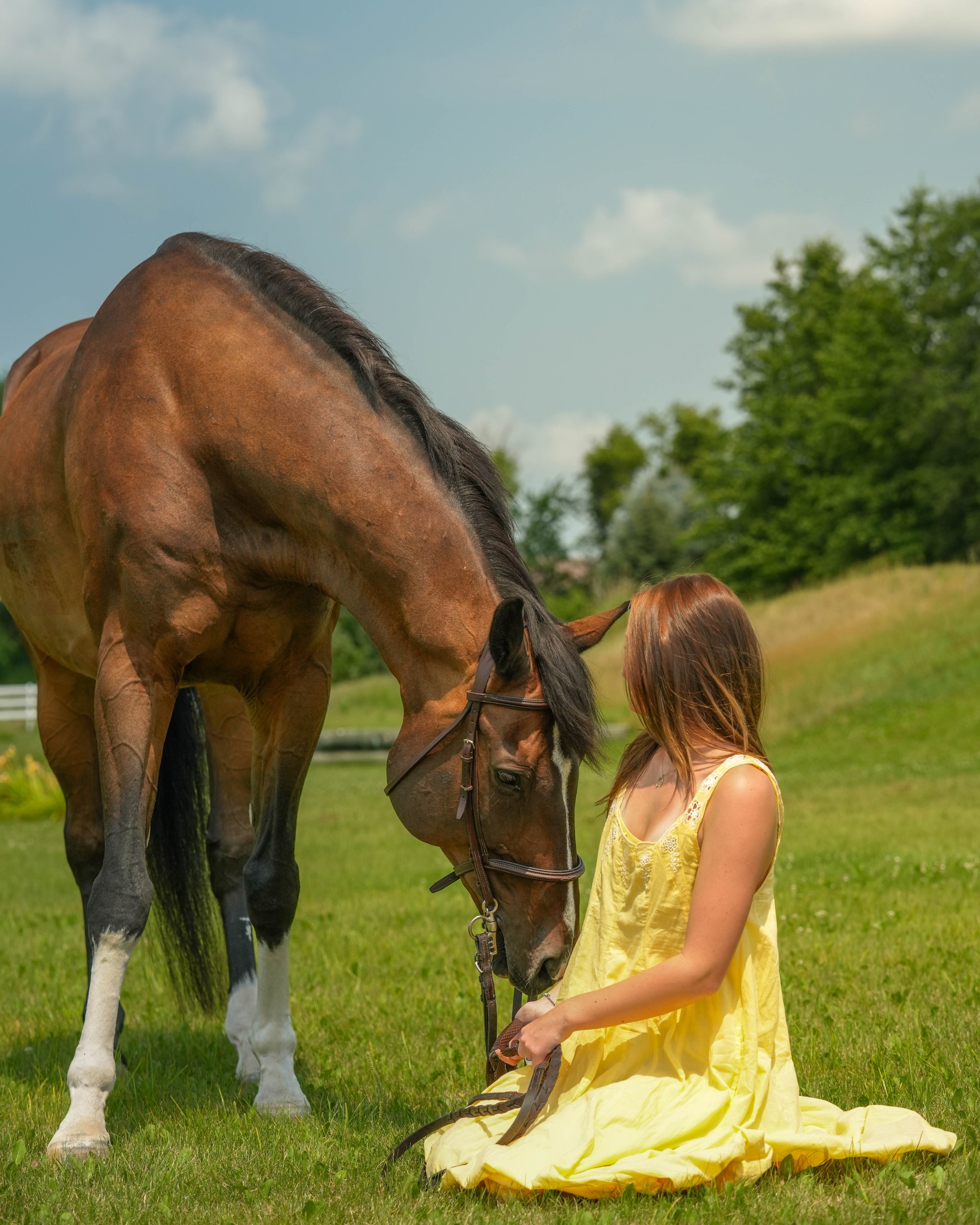 A girl and her horse standing close